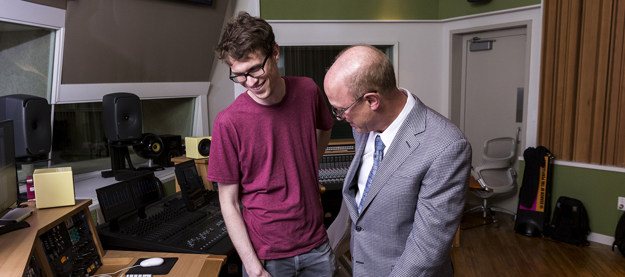 Student and teacher work in a music engineering lab