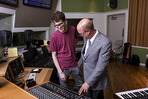 Student and teacher work in a music engineering lab